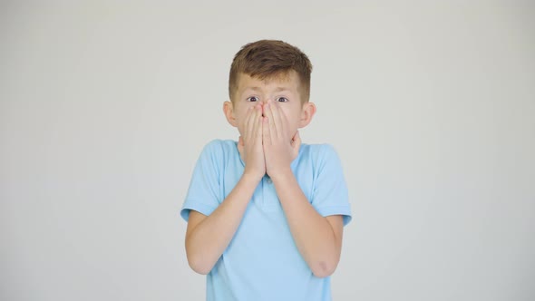 Nice Boy Feeling Stunned and Amazed Looking at Camera White Studio Background alt