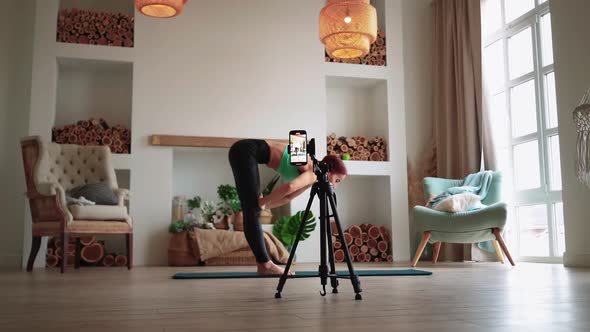 Athletic Woman is Filming Her Fitness Video Blog alt