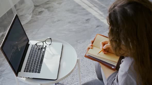 Woman Make Notes in Paper Diary