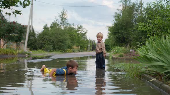 Childhood, Happy Boy with Good Health, Together with His Young Brother, Enjoys Games and Lies in alt