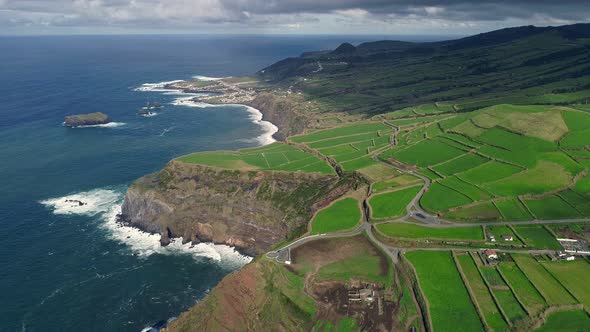 Sao Miguel Island, Azores, Portugal. Flying Over a Farm with Green Fields. Steep Shore of Atlantic
