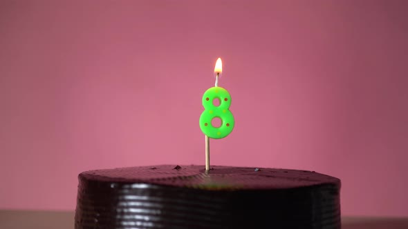 Chocolate Birthday Cake with Wick Lighting Trying to Blowout Candle alt