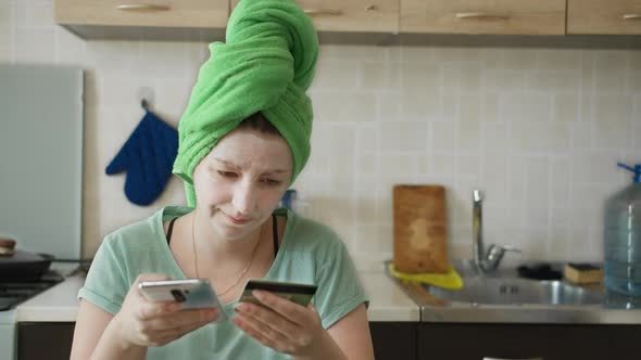 Brunette Woman Got Out of the Shower and Makes Purchases in the Online Store Using the Phone