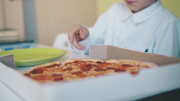 Schoolboy in Shirt Has Lunch with Pizza at Table Slow Motion alt