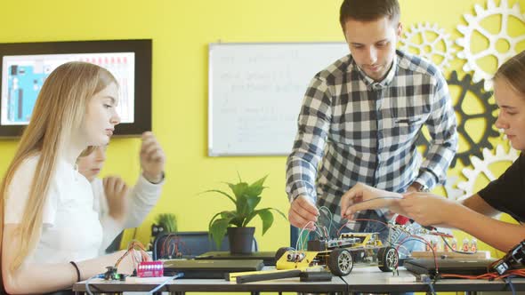 Group of Students and Teacher in Robotics Club