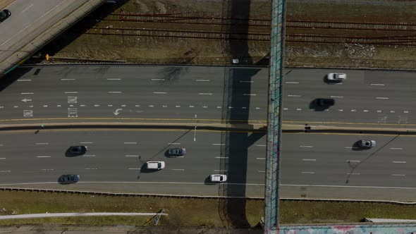 Top Down Panning Footage of Cars Driving on Multilane Highway Along Railway Track alt