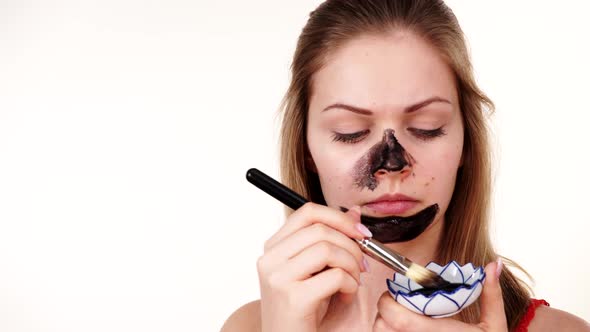Girl Apply Black Carbo Mask to Face