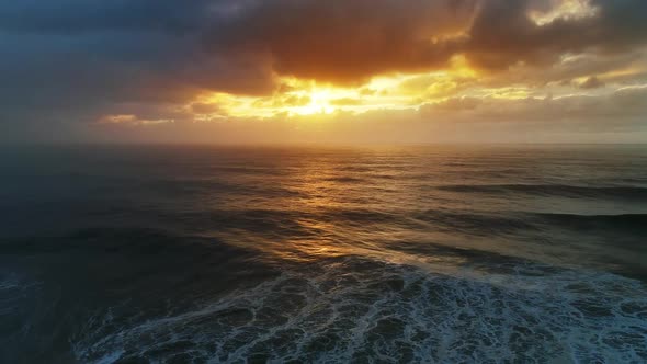 Aerial View on Big Waves and Dramatic Sunset Sky alt