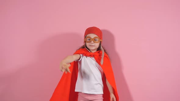 Awesome Girl Child Wearing Red Cloak and Helmet of Pilot Raised Hands Up Holding Wooden Toy Plane alt