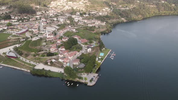 Aerial top down view small village riverfront, Tâmega and Douro river intersection, Entre-os-rios
