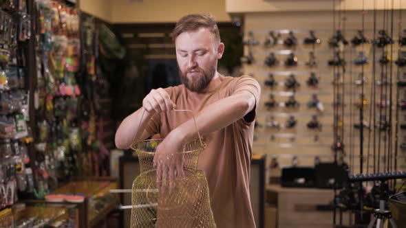 Customer Chooses a Metalic Fish Tank in a Fishing Store alt