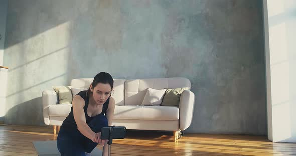 Trainer Turns on Camera on Smartphone to Shoot New Video alt