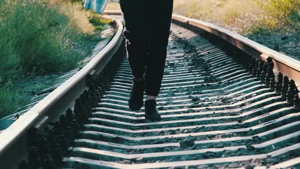 Young Beautiful Woman Walks Alone on the Railway Track alt