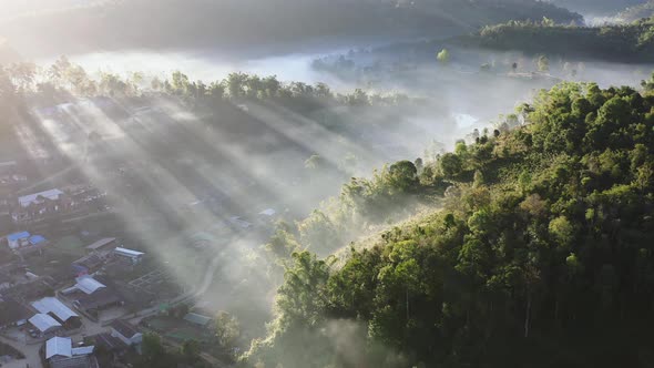 Aerial View of Sunrise with Fog Over Ban Rak Thai Chinese Village Near a Lake in Mae Hong Son alt