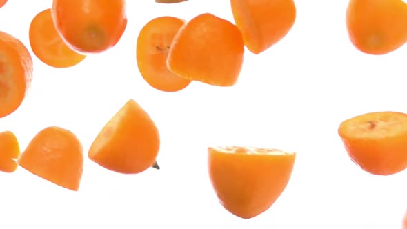 Closeup of the Fresh Delicious Orange Kumqat Halves Falling Diagonally alt