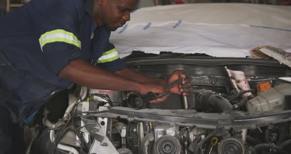 African man repairing car alt