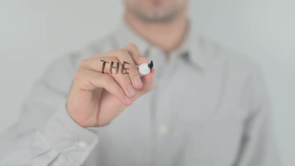 Dedicated to Excellence Man Writing on Transparent Screen alt