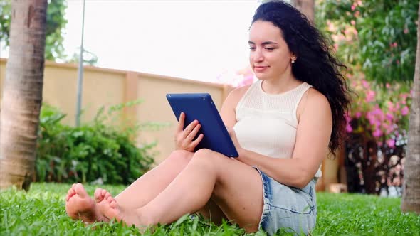 Worried Adult Woman Using Smart Phone Texting Message in a Park alt