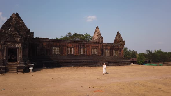 Lady walk near Khmer palace Vat Phou ruined Hindu Temple. Ancient architecture Champassak Laos Asia