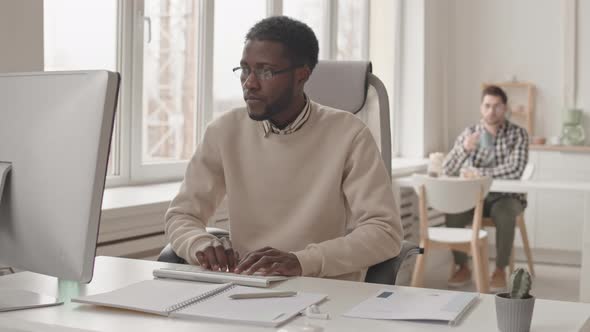 African-American Man Working on Computer in Office alt