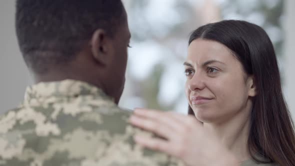 Closeup of Charming Loving Caucasian Woman and Affectionate African American Man in Military Uniform alt