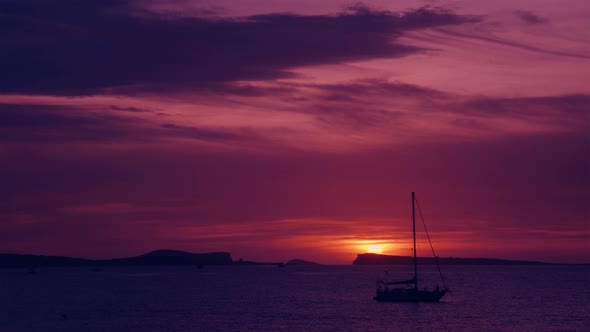 Sea Sunset behind the Mountain Islands with Sailing Ship and Bird Flying by  alt