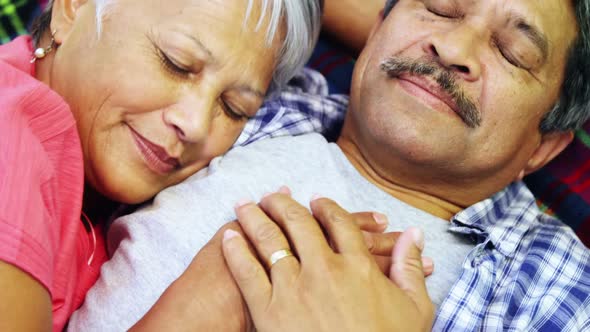 Senior couple laying on blanket alt