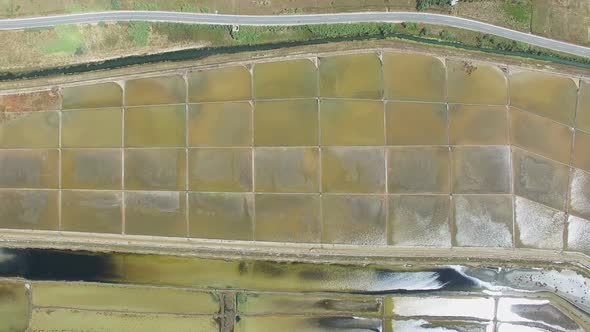 View from above of paved road passing the salt ponds on Pag island, Croatia alt