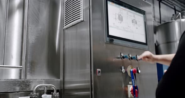 A Person Monitors Production on a Touch Screen Computer in a Manufacturing alt