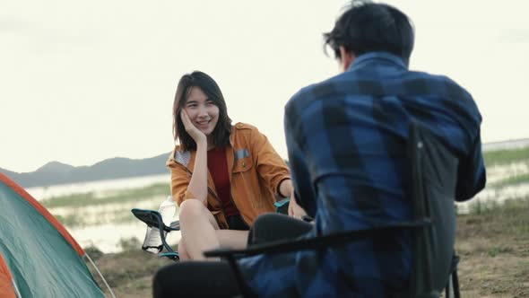 Caucasian couple campers trekking in mountains park taking photos enjoying vacation travel.