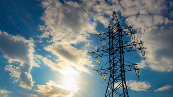 Time Lapse of High Voltage Pole on Background Blue Sky with Moving Sun and Clouds