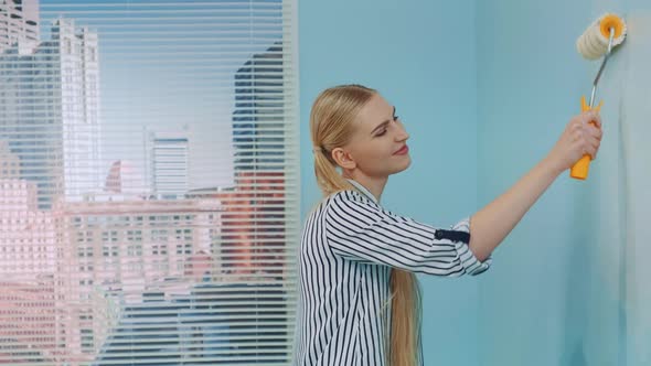 Woman Painting a Wall at Office. alt