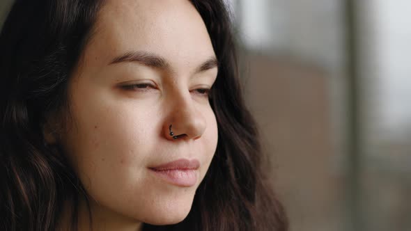 Extreme Closeup Female Young Face with Perfect Skin Natural Makeup Dark Eyes Pierced Nose Earring alt