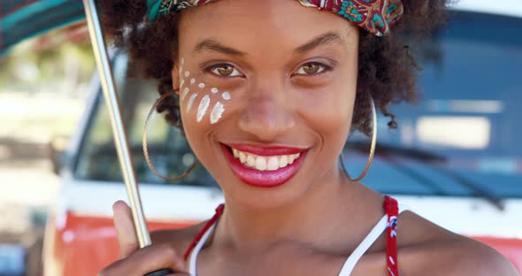 Smiling woman standing with umbrella in park 4k alt