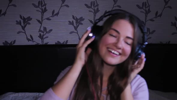 Happy teenage vibing to the music with headphones alt