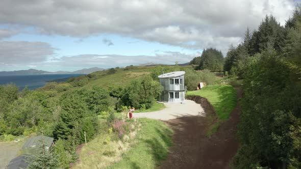 AERIAL - establishing shot of a quirky aluminum house in Scotland alt