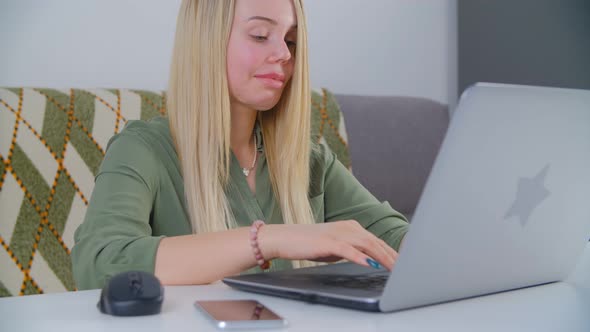Professional freelancer woman typing text on laptop at home during lockdown alt