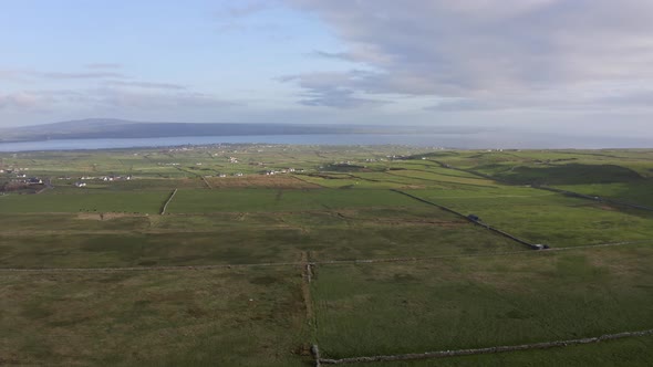 Aerial View of Irish Green Rural Fields During a Summer Sunset in Ireland alt