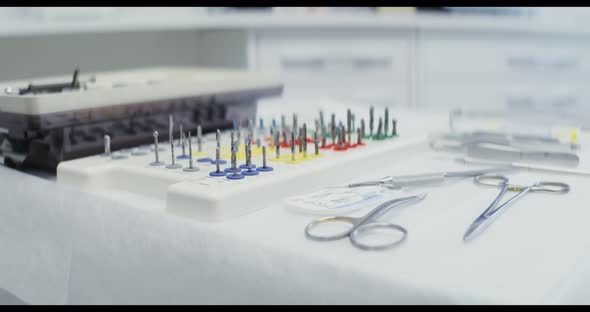 A Dentist's Table Prepared for Work with Dental Instruments Laid Out on It alt