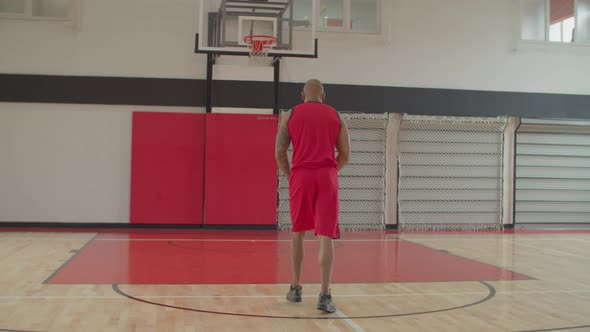 African Basketball Player Taking Free Throw Indoor alt