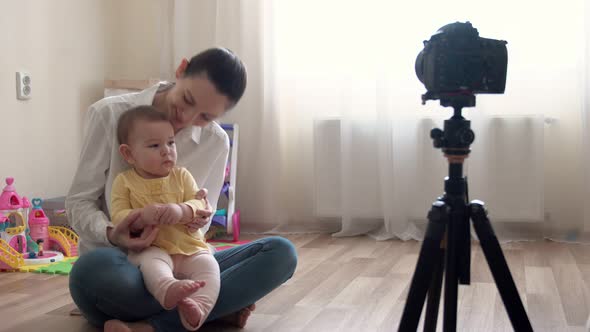 Young Mother with Little Boy Recording Video on Camera and Vlogging About Family and Childhood alt