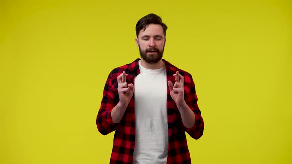 A Man Crossing His Fingers Makes a Wish Points to Himself Asking Who Me Puts His Palms Together Puts alt