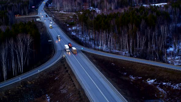 Aerial View of The Truck that Rides on A Huge Interchange at Sunset