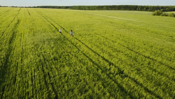Small Family Walking in Field alt