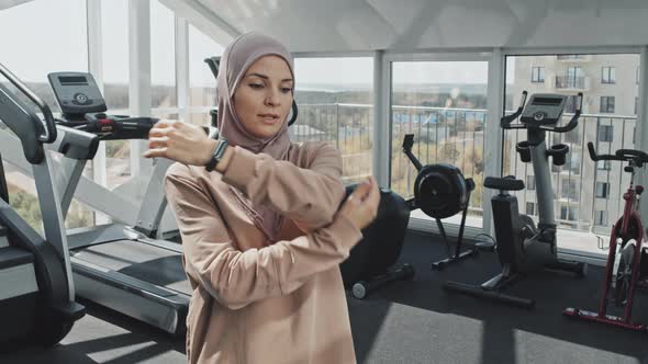 Woman in Hijab Exercising in Gym alt