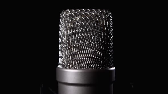 Studio Condenser Microphone Rotates on Black Background