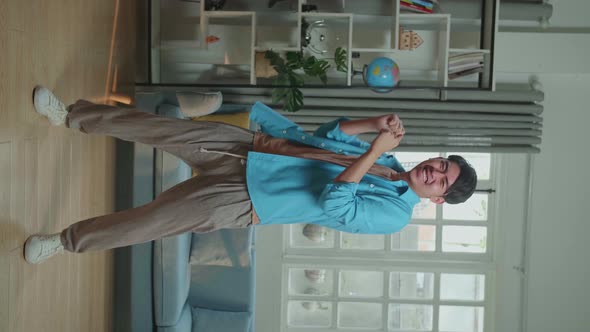 Full Body Of Asian Man Dancing While Shooting Video Content For Social Networks At Home alt