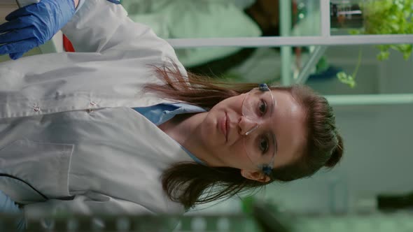 Vertical Video Portrait of Chemist Woman in White Coat Working in Pharmaceutical Laboratory alt
