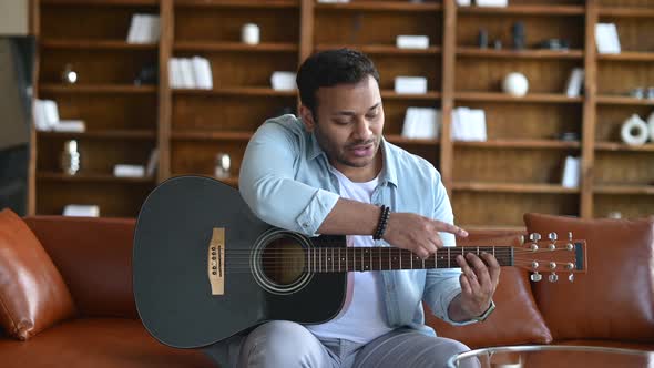 Online Tutor is Teaching Playing Guitar Conducts Webinar Online Masterclass alt