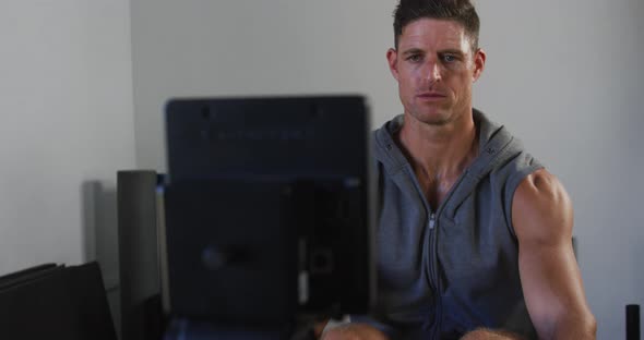 Fit tired caucasian man exercising, practicing rowing inside gym, Stock ...